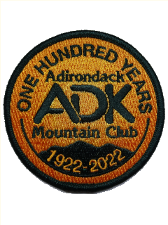 Orange patch with green image of mountains and ADK logo