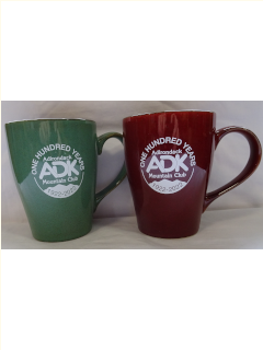 green and red ceramic mug with cream colored ADK logo