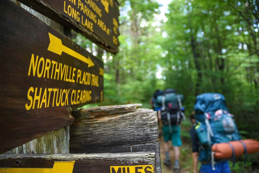 hiker passing NPT trail sign