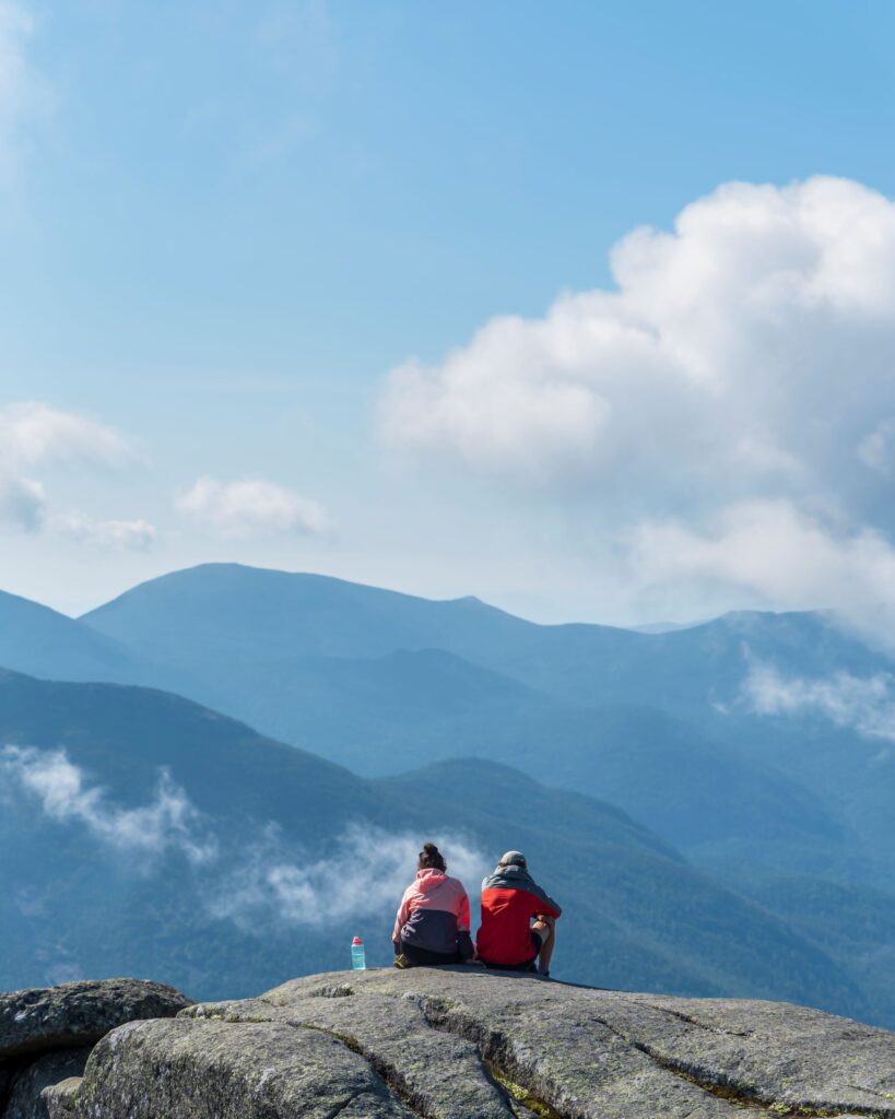Two people sitting on a summit