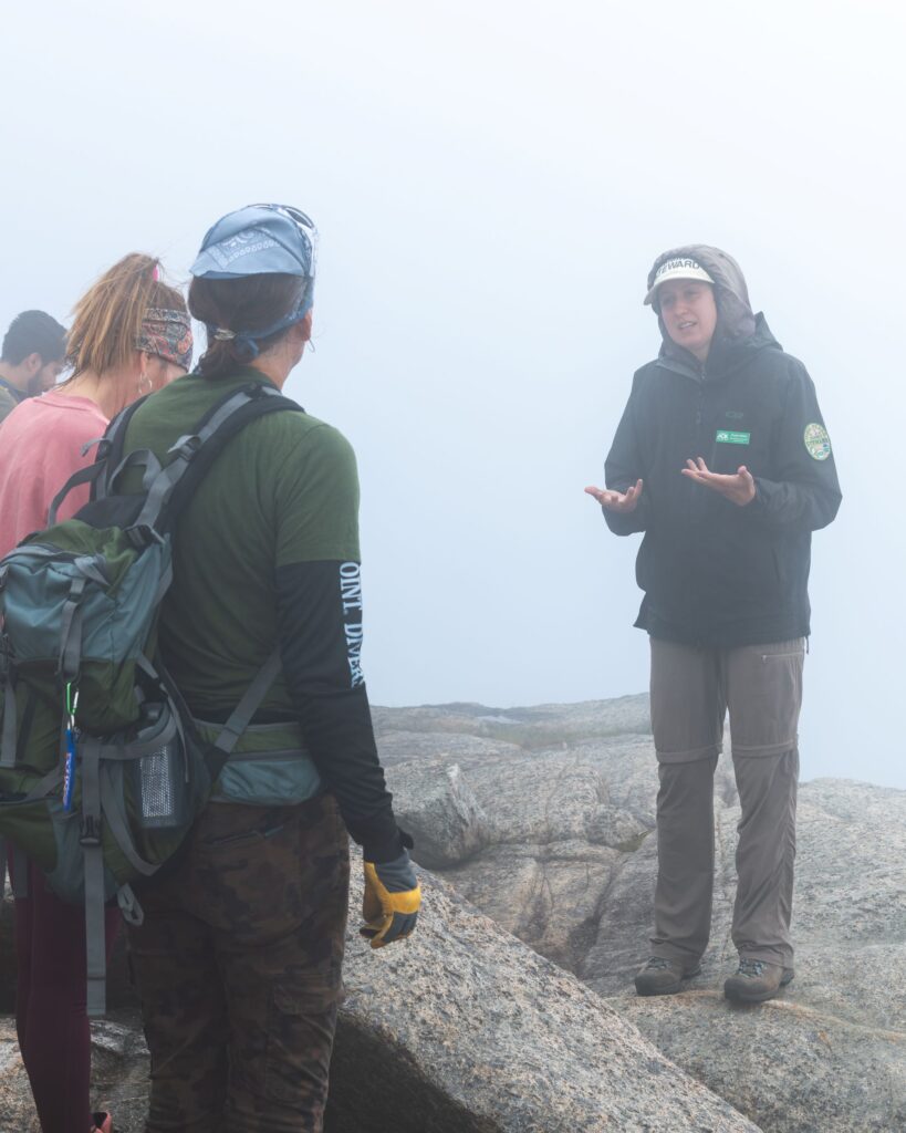 A woman speaks to hikers