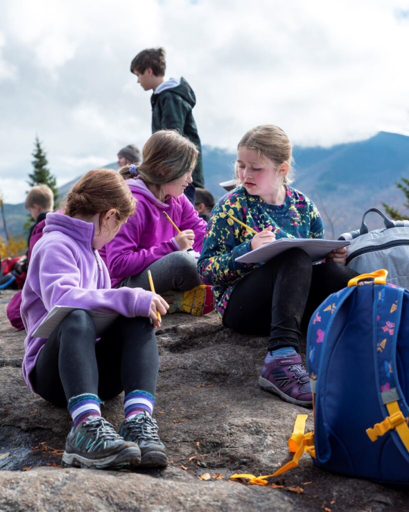 Children sitting on a summit