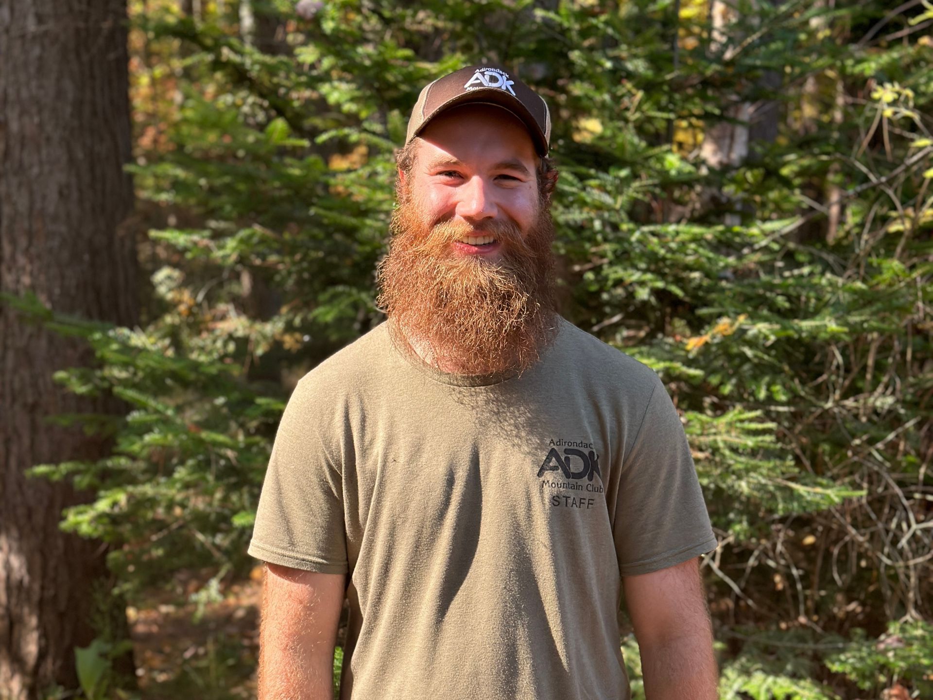 picture of a man with pine tree in the background