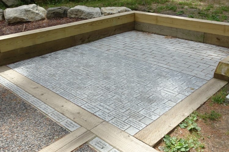 memorial pavers arranged in a square along pathway