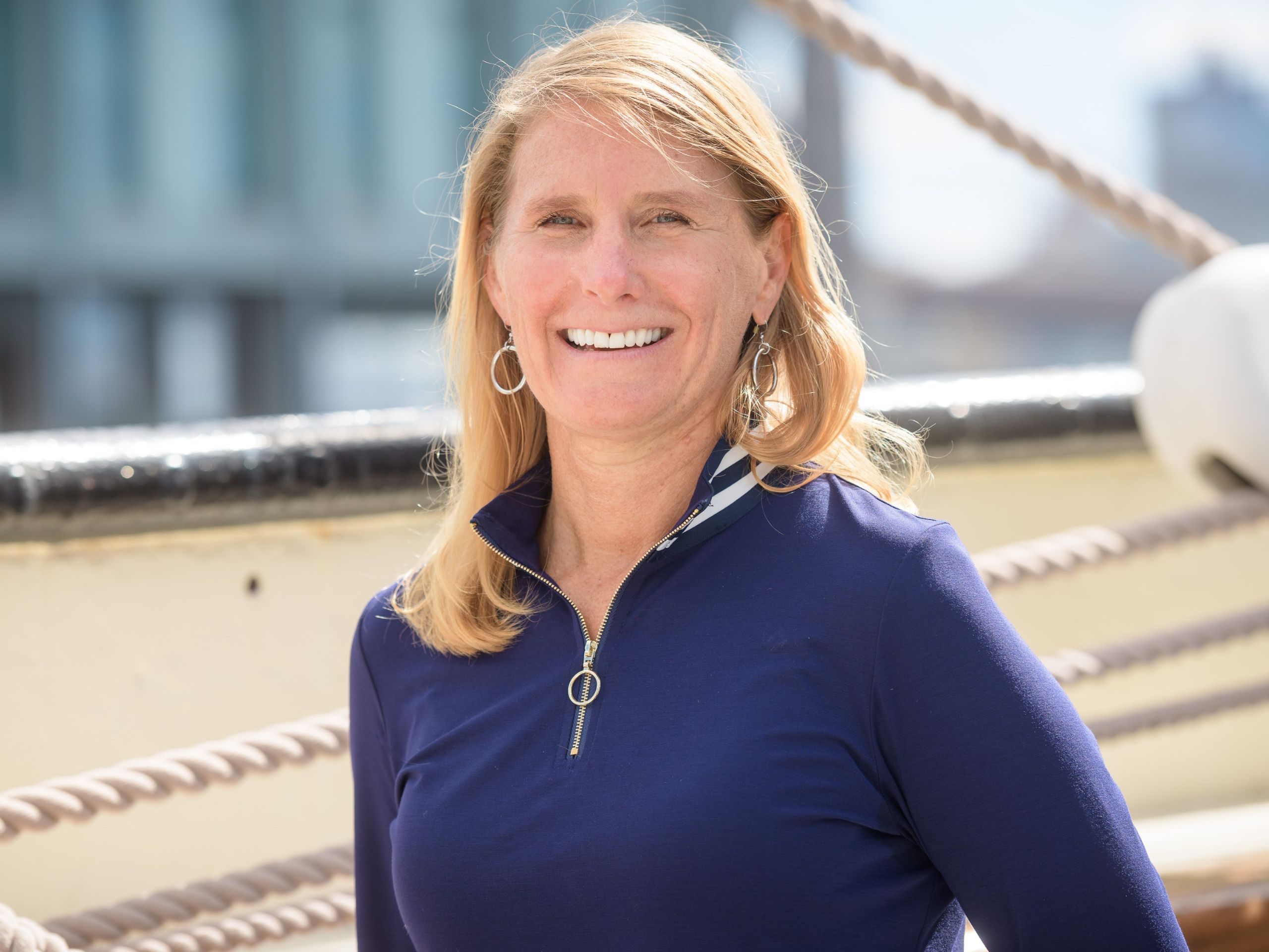 photo of a woman outdoors wearing a blue jacket