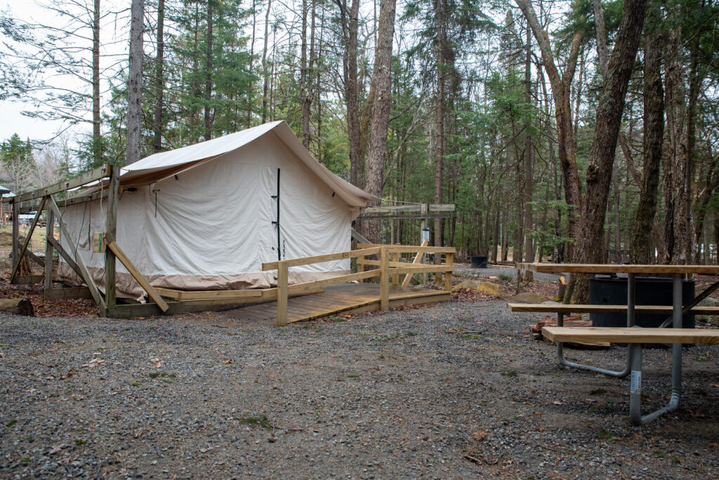 an accessible canvas cabin on a wood platform for camping in the Adirondacks