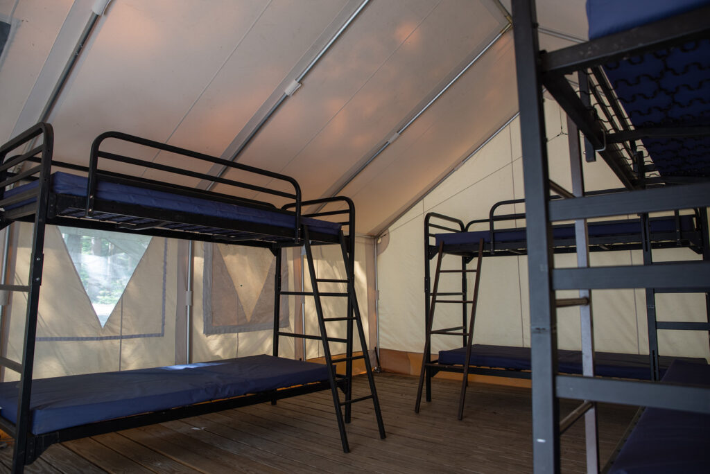 bunk beds inside a canvas cabin at ADK's Heart Lake Program Center in Lake Placid