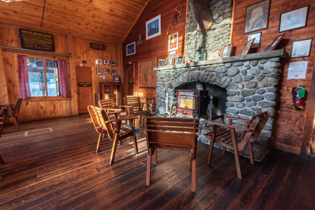 a large living room with a fireplace in an adirondack lodge