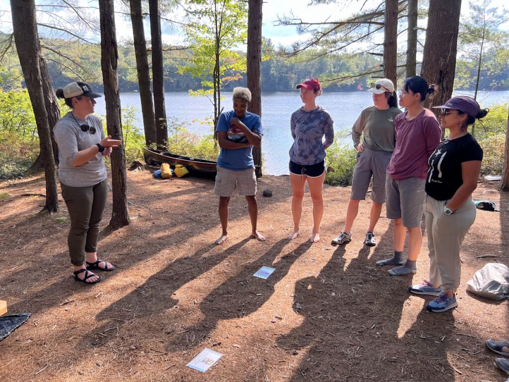 people by a lake taking a Leave No Trace course taught in American Sign Language