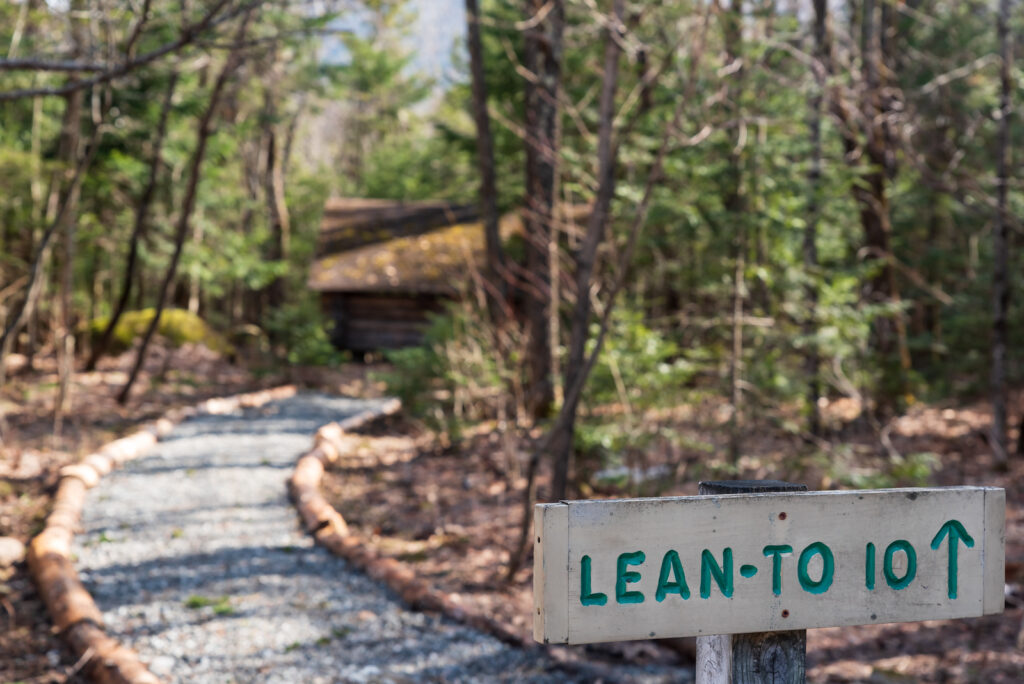 a sign that says "lean-to 10" in the woods