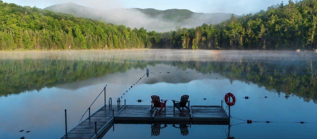 a dock on a lake in the adirondacks