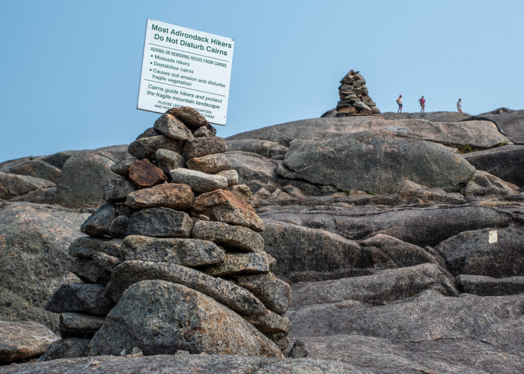 a cairn with signage on the summit of Cascade Mountain
