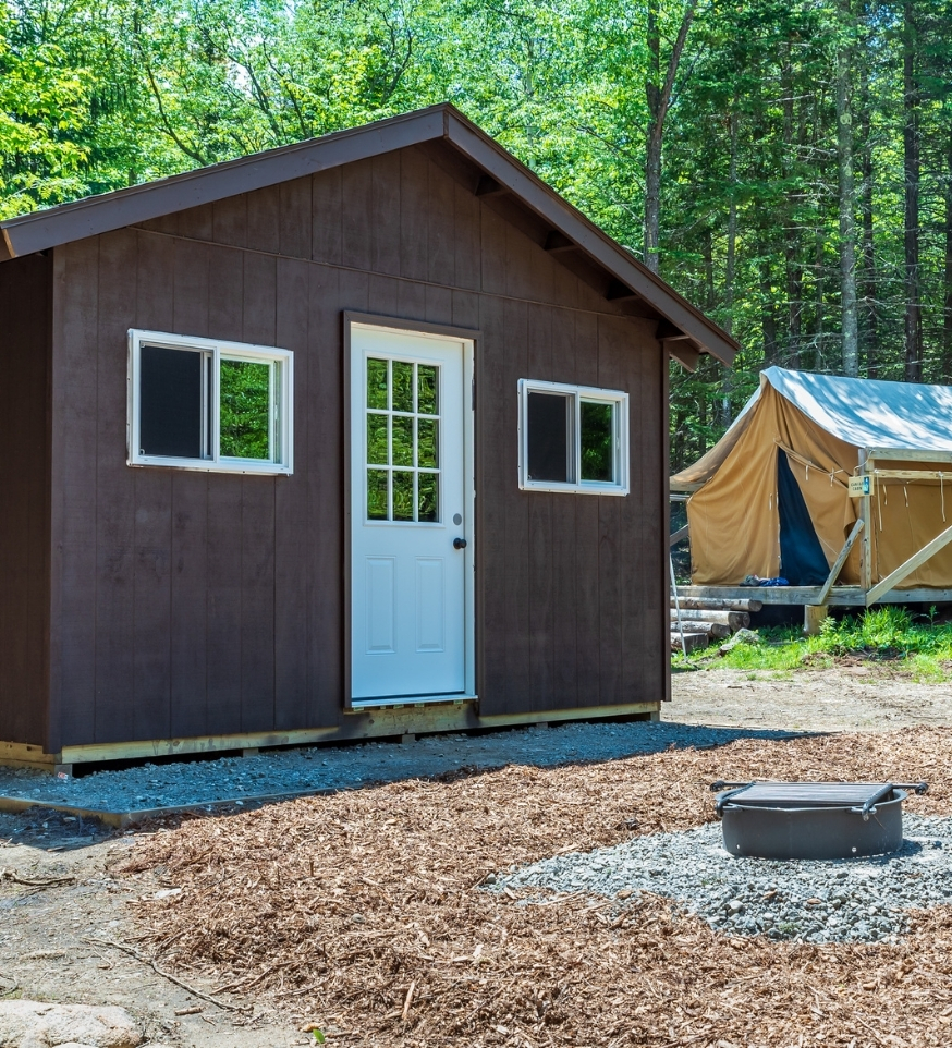 a cabin with a fire ring in the adirondacks