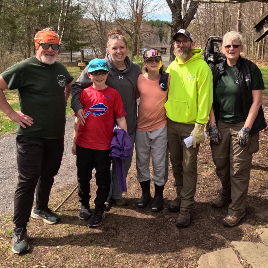 a group of hikers pose for a photo on the trail