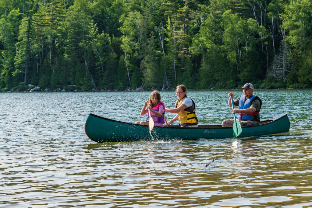 a family in a canoe on heart lake
