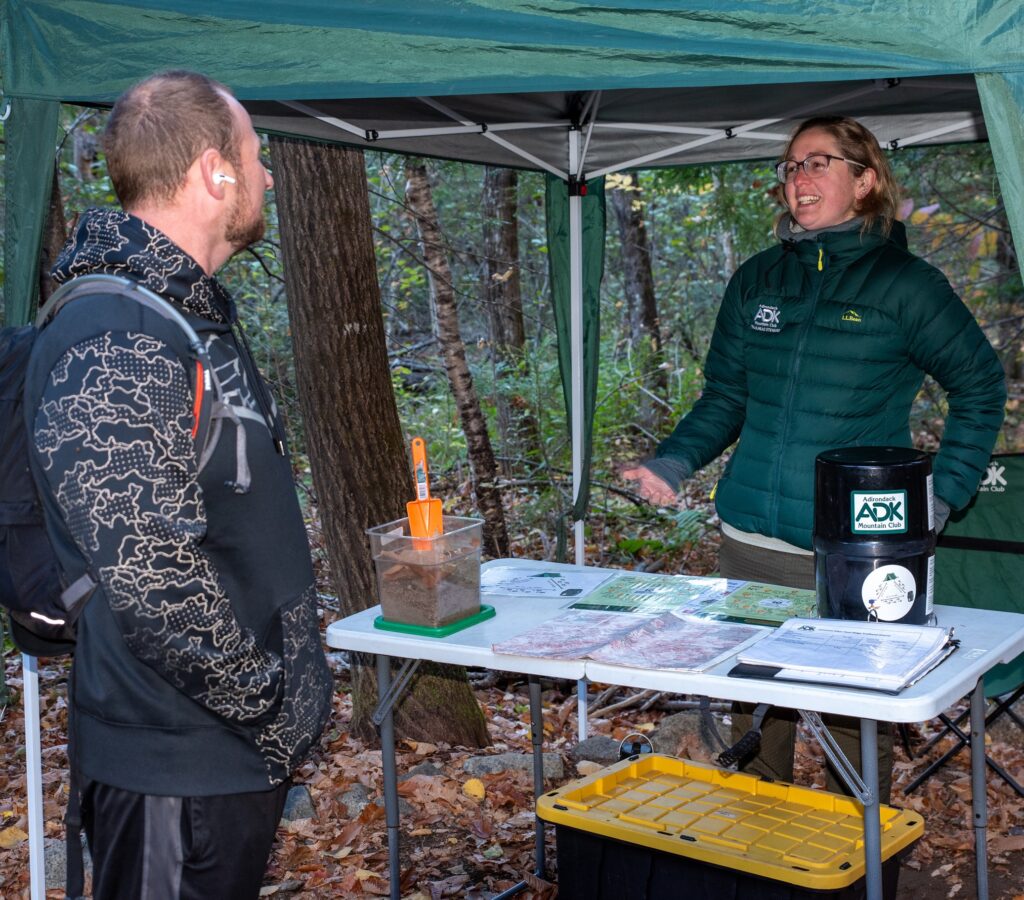 route 73 trailhead steward speaks to a hiker