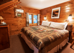 Private room with king bed and adirondack decor in ADK Loj
