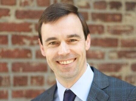 headshot of man in a suit