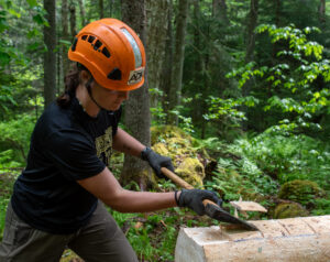 trail working chops wood using an axe