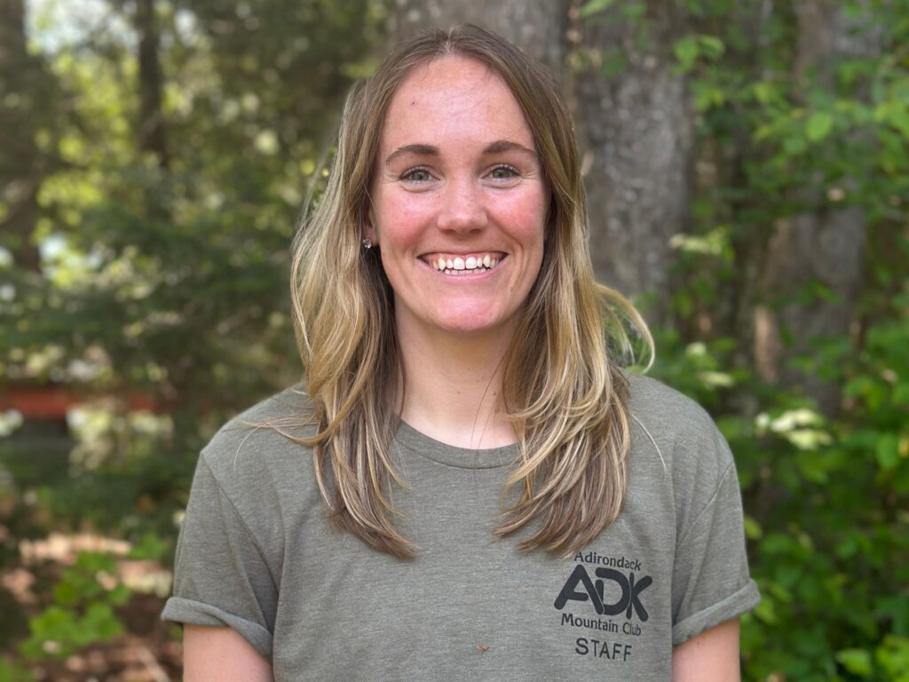 portrait of smiling woman standing in the woods