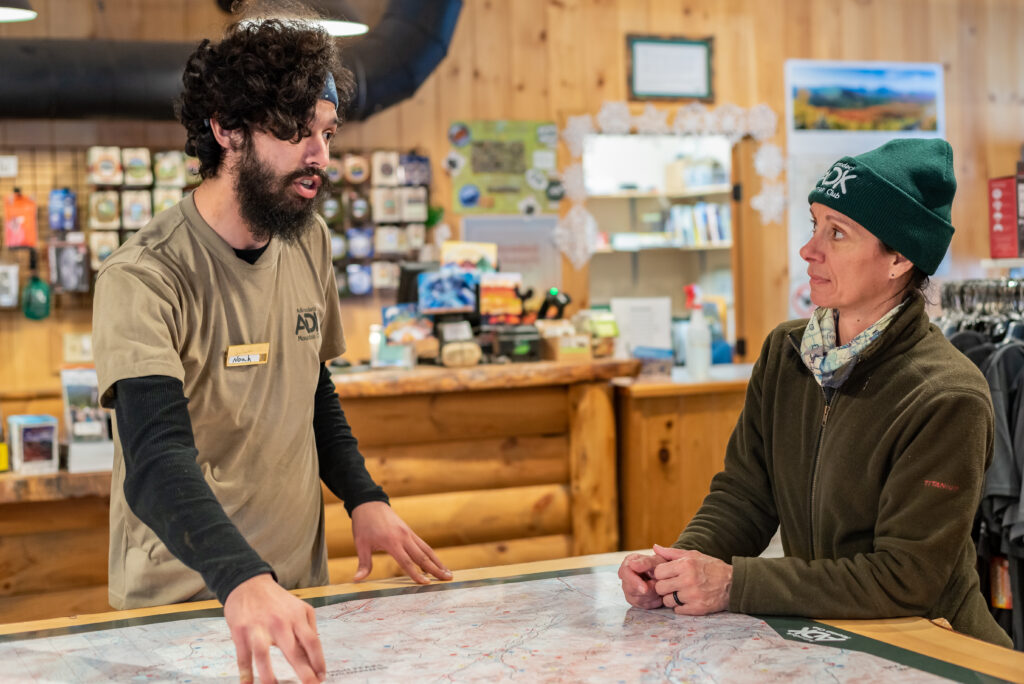 ADK staff members at a map table in the High Peaks Information Center