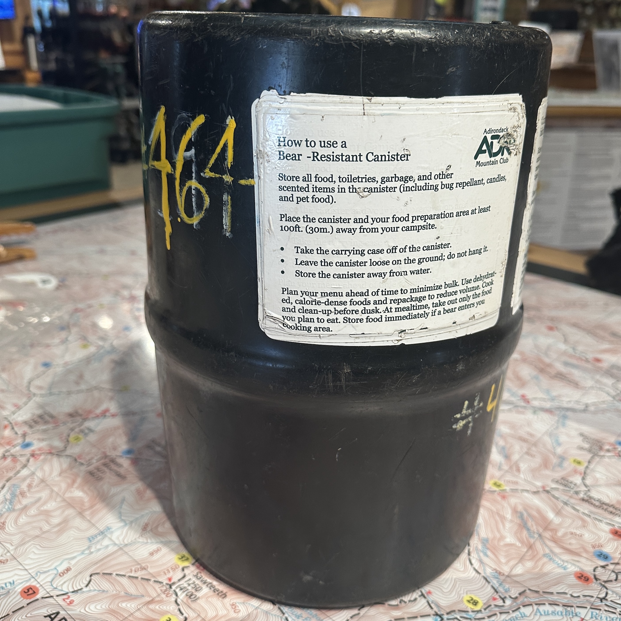 Garcia backpackers cache bear can on a map table