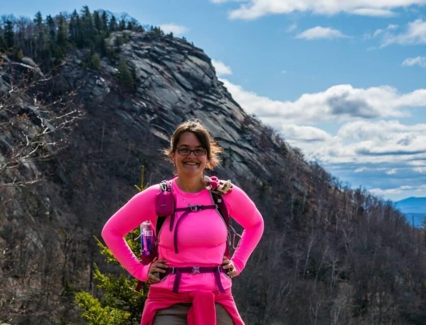 woman wearing pink near a mountain summit