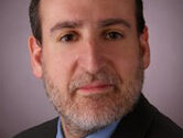 headshot of man wearing a suit