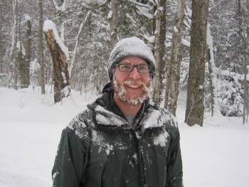 man in the snow wearing a winter hat