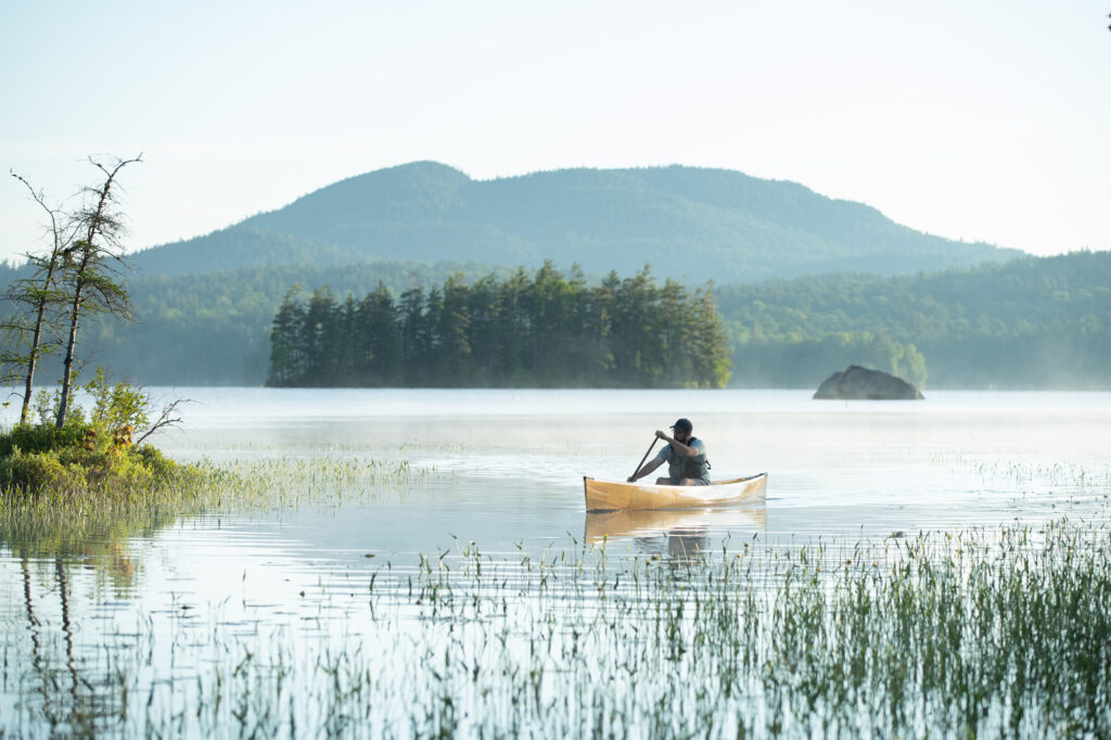 solo canoe paddling in saranac lake region