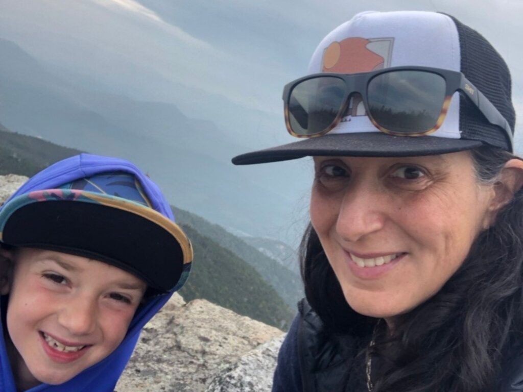 woman and a boy at a mountain summit