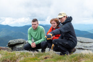 summit steward speaking to two hikers