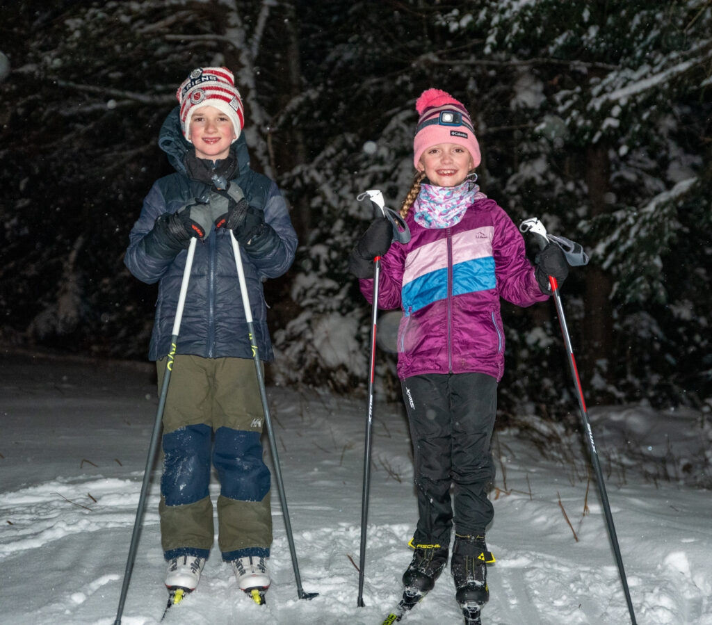 two young skiers at night