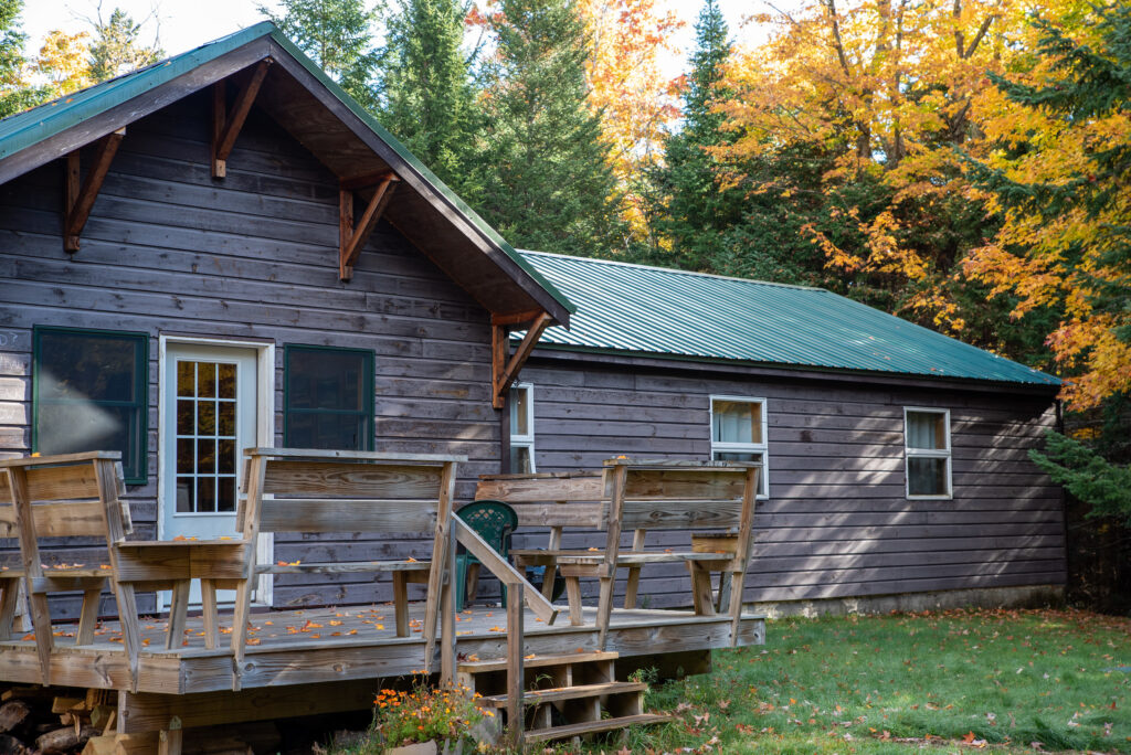a cabin in the adirondacks with a back deck