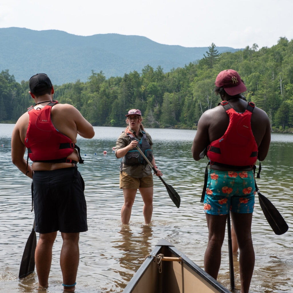 a paddle instructor teaching technique at heart lake
