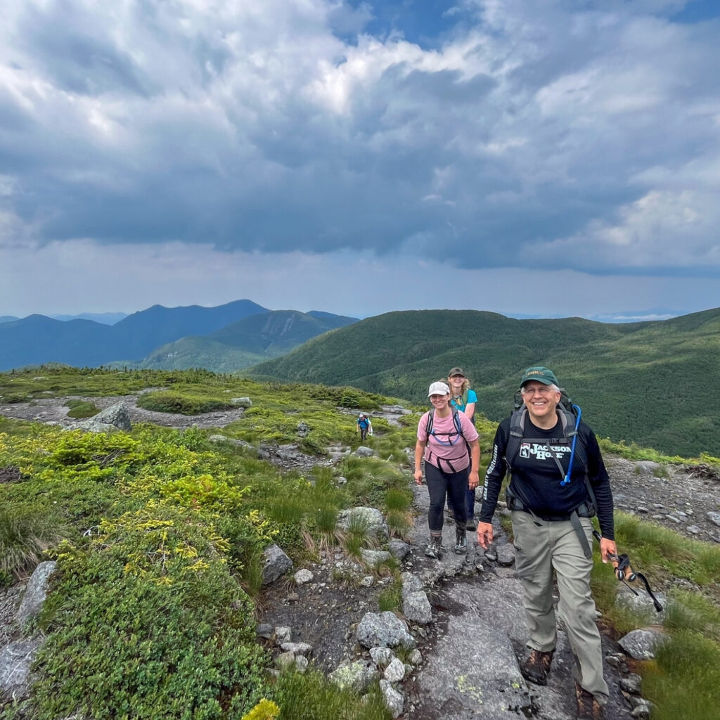 a group of hikers on near on the summit of a high peak in the Adirondacks
