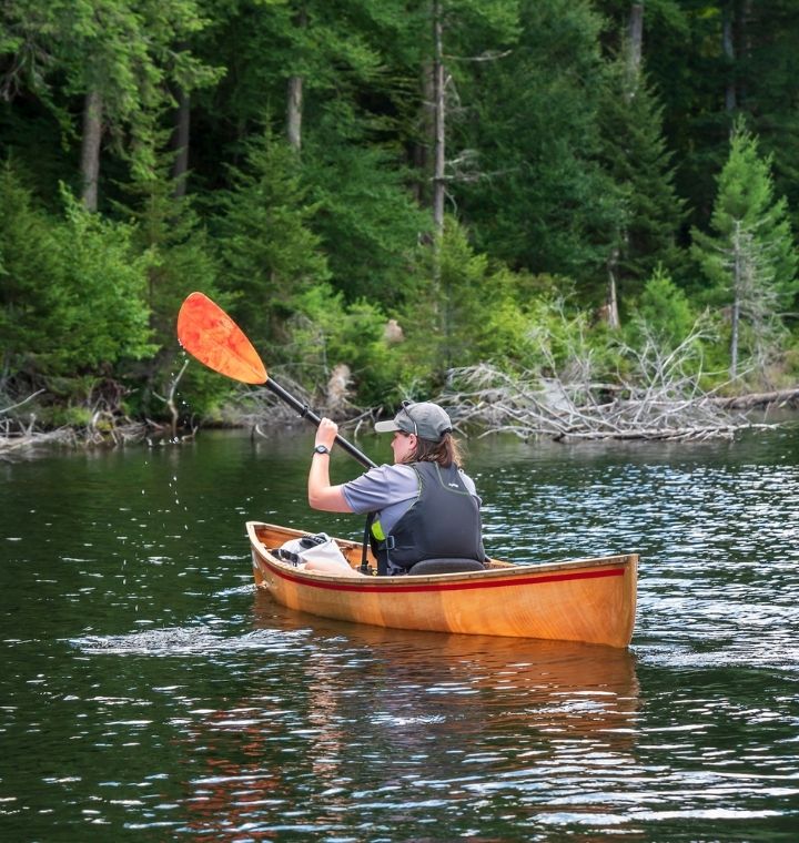 paddler on lake in canoe