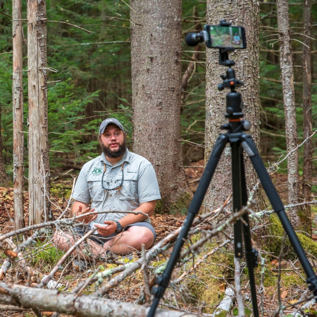 a man recording a video using a cell phone on a tripod