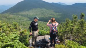 two hikers on a mountain summit