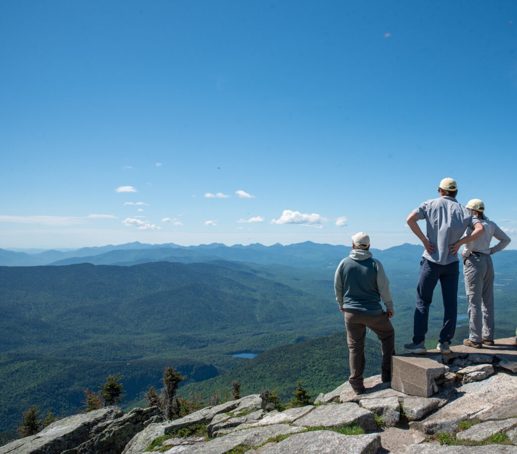 summit stewards looking out from the summit of whiteface