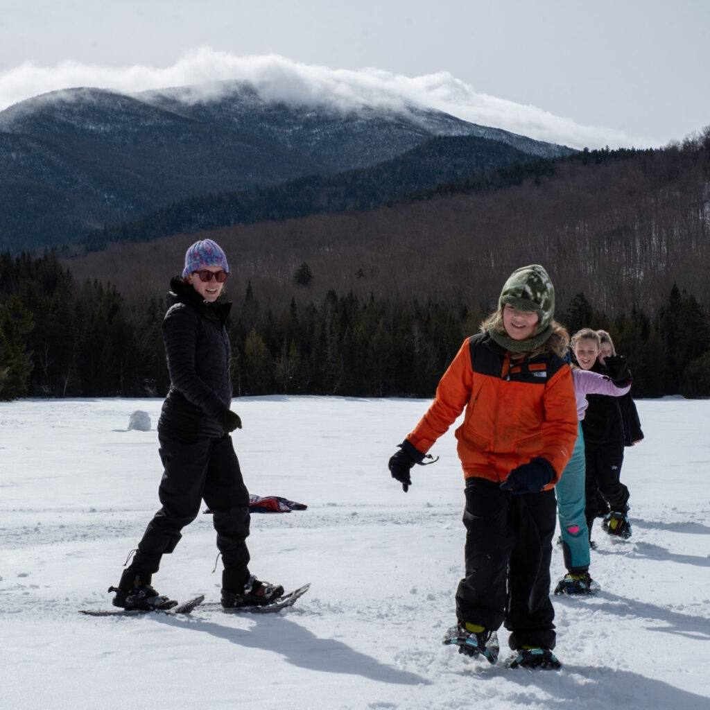 students snowshoeing on heart lake