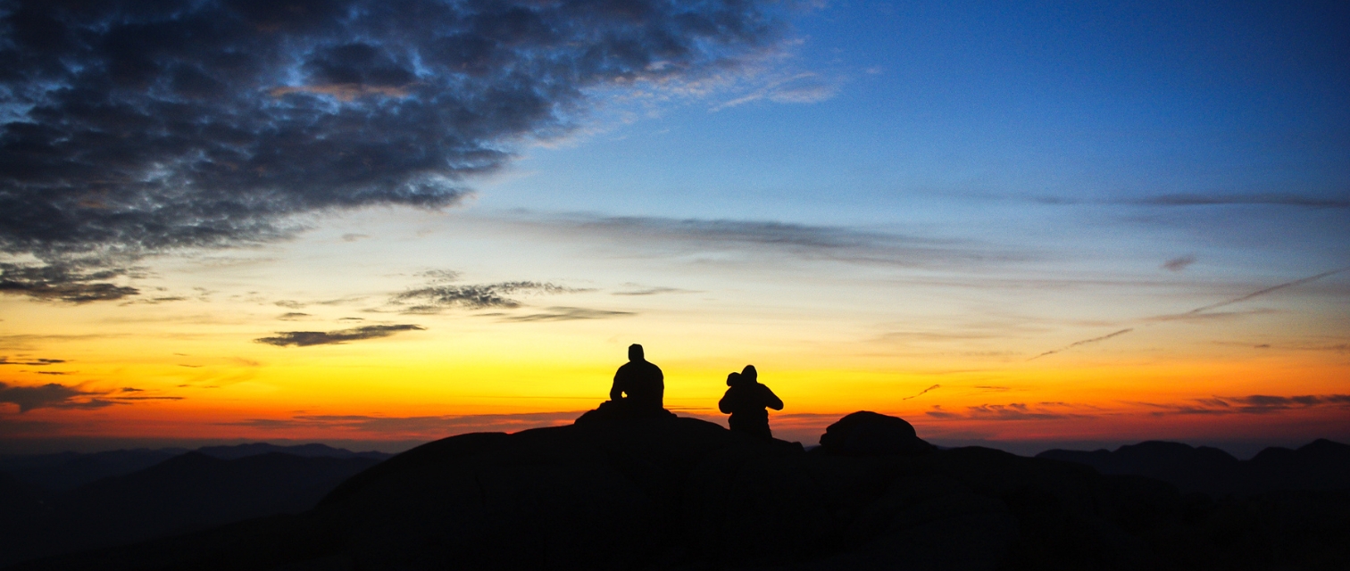 two hikers at the summit of Algonquin at sunrise