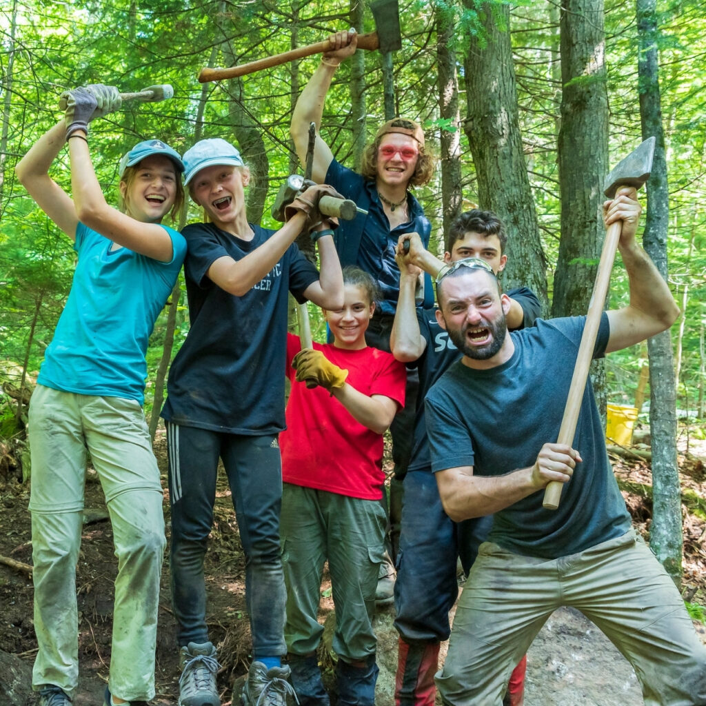 volunteers post with axes and sledges