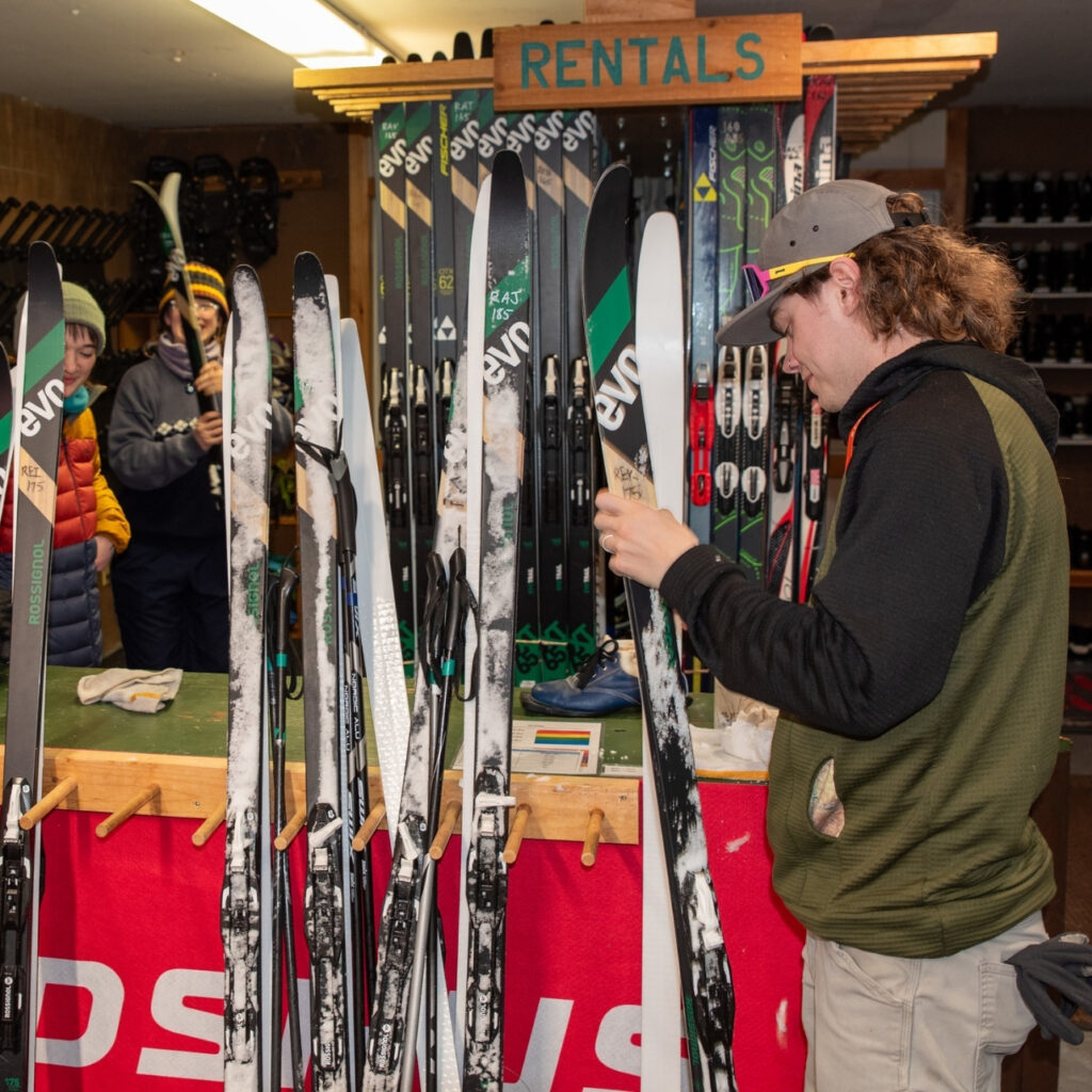 man wearing a hat handles ski rentals