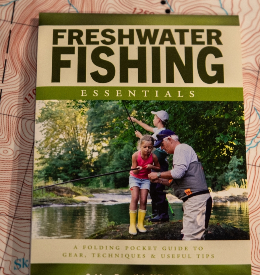 freshwater fishing essentials book on a map table
