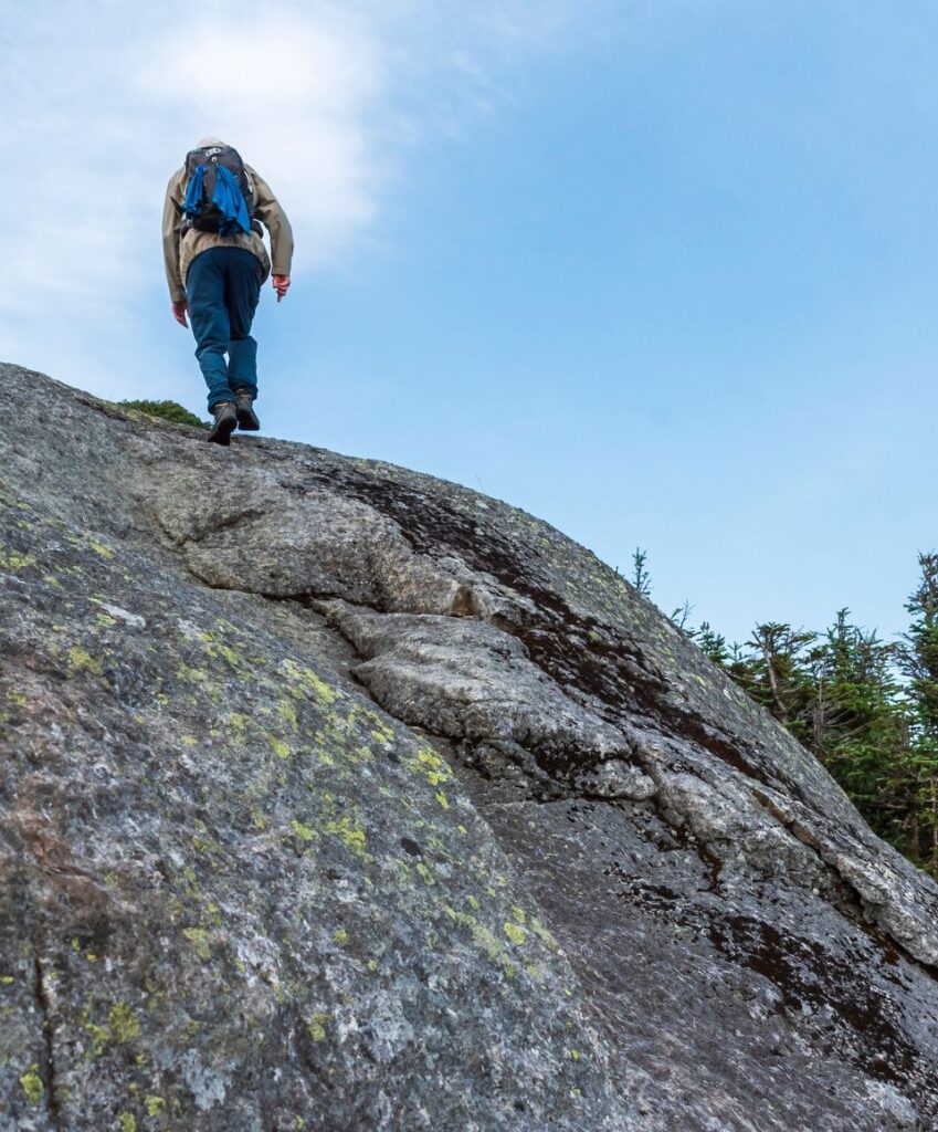 hiker climbs to the summit of iroquois