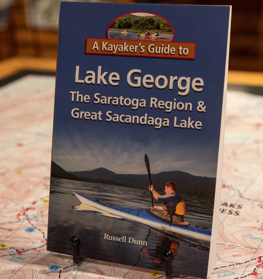 kayaker's guide to lake George book on a stand on a map table