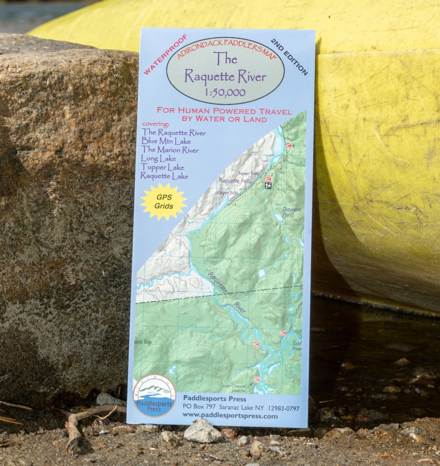 raquette river paddlers map leaning against a rock and yellow kayak