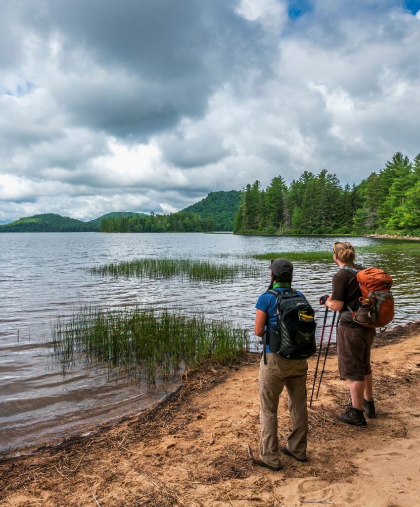 two hikers look out over lake lila
