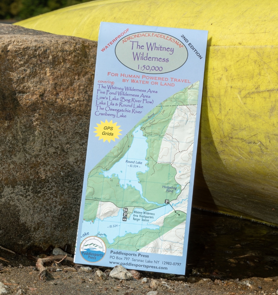 Whitney wilderness paddling map leaning against a rock and a kayak